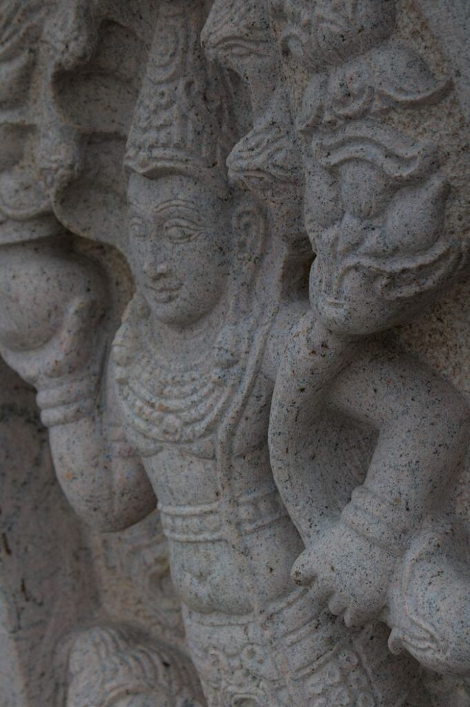 Intricate stone carving of a Hindu deity in Sri Lanka, showcasing traditional art and culture.
