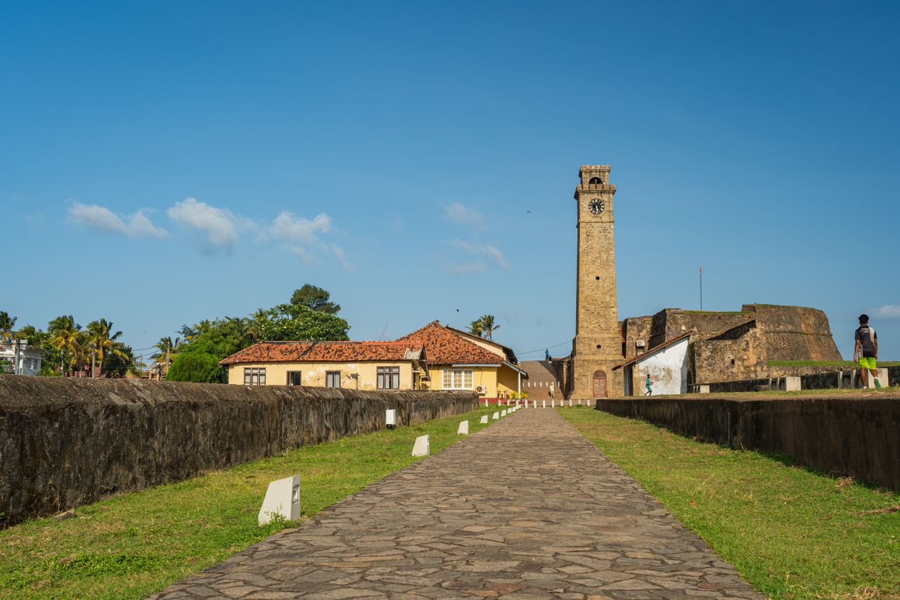 Explore the historic Galle Fort with its iconic clock tower under a clear, sunny sky.